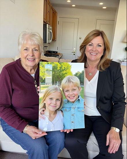 Two women holding a photo of two children in a kitchen.